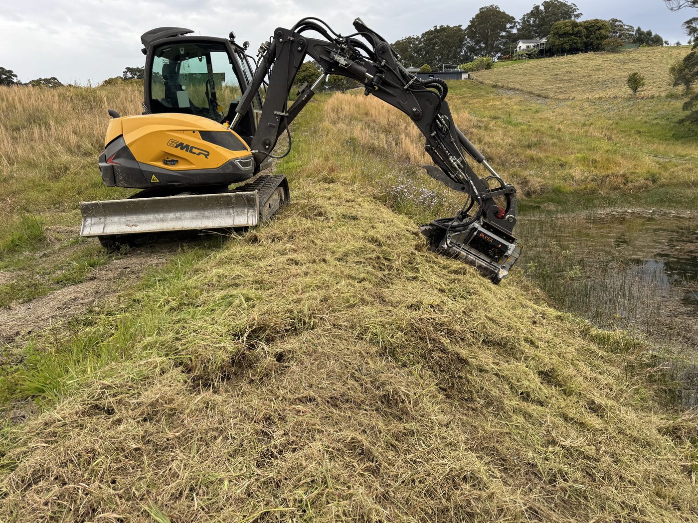 Mulching long grass down a dam bank, North Boambee Rd Coffs Harbour